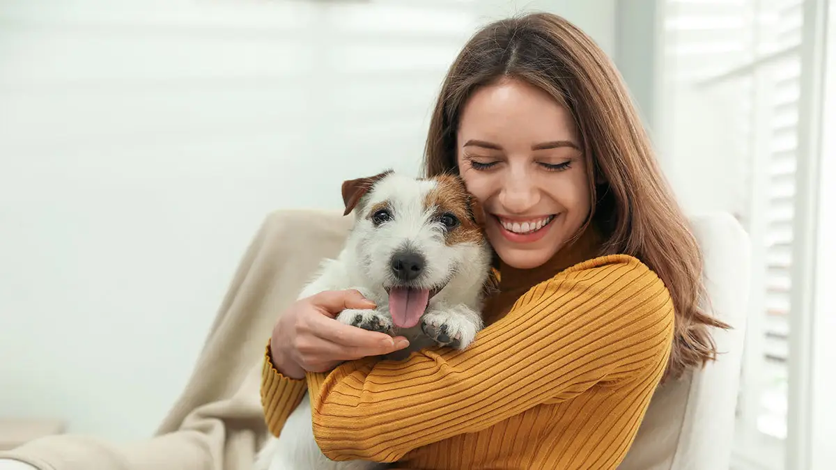 Happy woman embracing her puppy